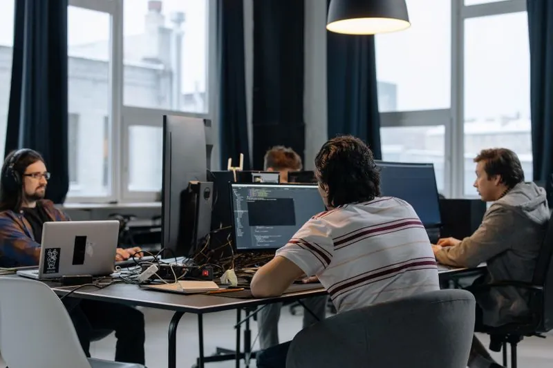Tech startup team working in an office, SaaS and startup insurance